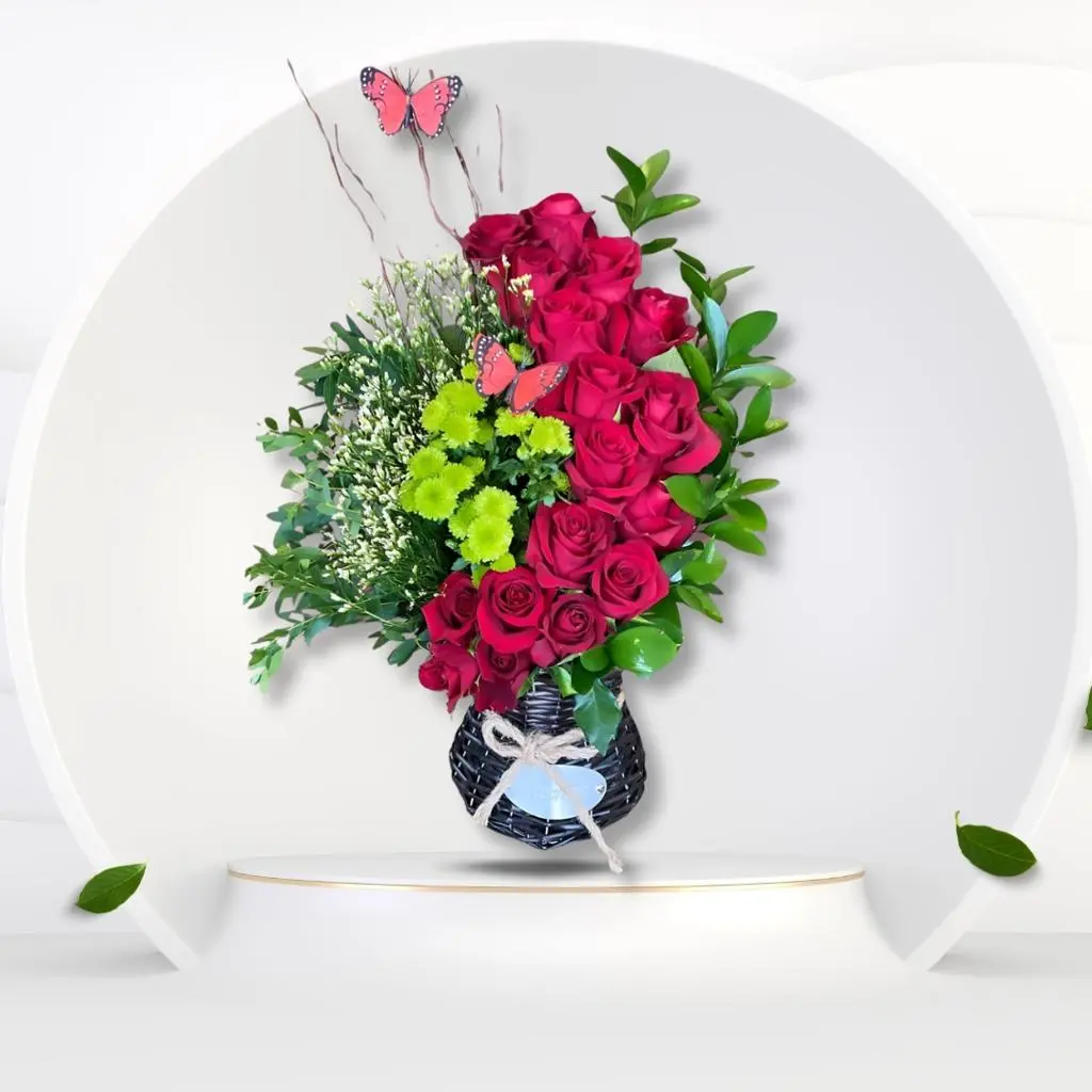 Black Basket Elegantly Decorated With Red Roses Green Plants And Butterflies